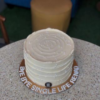White cake with pearl dots and bye-bye-single-life message, by DOT Cake Art