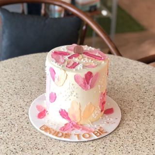 White cake with pink and peach floral strokes, by DOT Cake Art