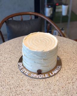 Pale blue cake with wavy buttercream texture, by DOT Cake Art