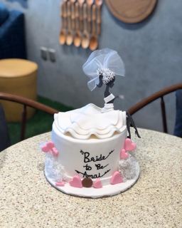 White cake with bridal gown, veil and hearts, by DOT Cake Art