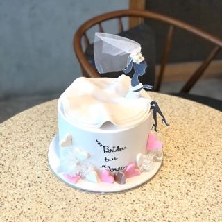 White cake with bride topper, veil and pink hearts, by DOT Cake Art