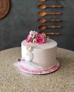 White cake with pink roses and veiled bride, by DOT Cake Art