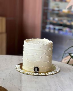 Plain white cake with pearls and bye-bye-single-life message, by DOT Cake Art