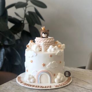 White cake with little bear, clouds and rainbow, by DOT Cake Art