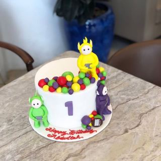 White Teletubbies cake with colorful balls, by DOT Cake Art