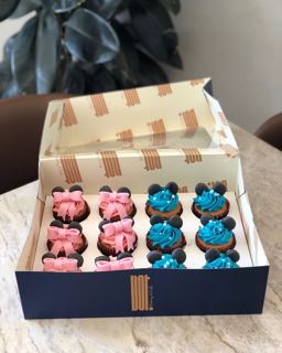 Box of Mickey and Minnie cupcakes in pink and blue, by DOT Cake Art