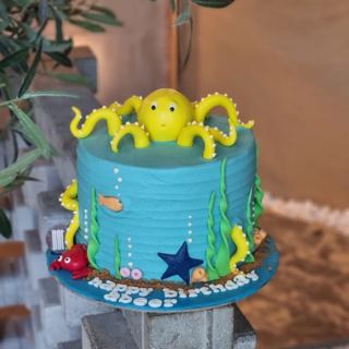 Blue under-the-sea cake with yellow octopus and seaweed, by DOT Cake Art