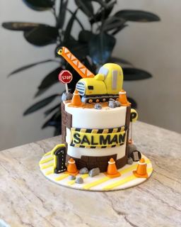 Two-tier construction cake with excavator and traffic cones, by DOT Cake Art