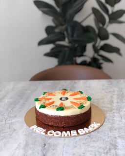 Carrot cake with carrot toppers, welcome back, by DOT Cake Art