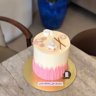 Pink cake with nursing and first-aid toppers, by DOT Cake Art