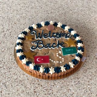 Giant cookie cake with flags, welcome back, by DOT Cake Art