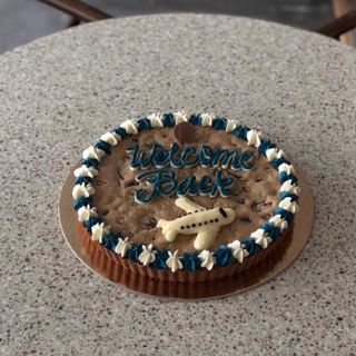 Giant cookie cake with plane, welcome back, by DOT Cake Art