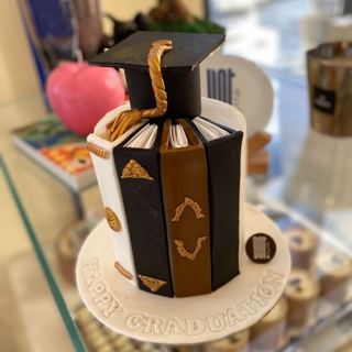 Book-stack cake with graduation cap, by DOT Cake Art