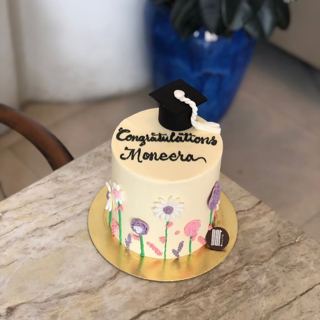 White cake with flowers and graduation cap, by DOT Cake Art
