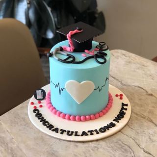 Blue cake with heart, heartbeat and grad cap, by DOT Cake Art
