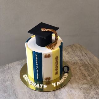Book-stack cake with graduation cap, by DOT Cake Art