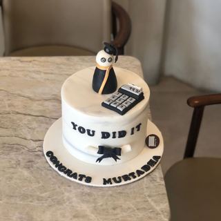 White cake with calculator and graduate character, by DOT Cake Art
