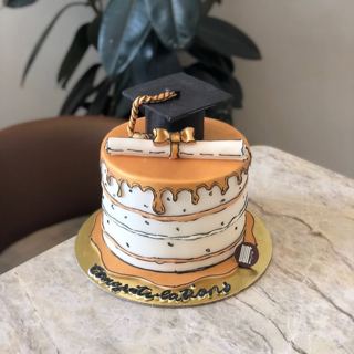White cake with gold drip and graduation cap, by DOT Cake Art
