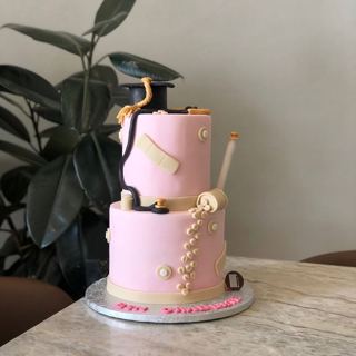 Two-tier pink cake with dental tools, by DOT Cake Art