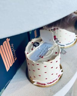 White cake with tiny red hearts and a note, by DOT Cake Art