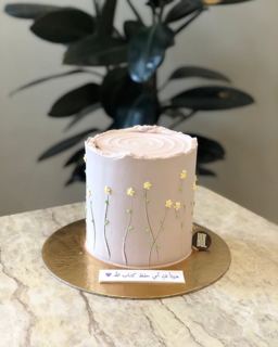 Pink cake with tiny yellow flowers for mom, by DOT Cake Art