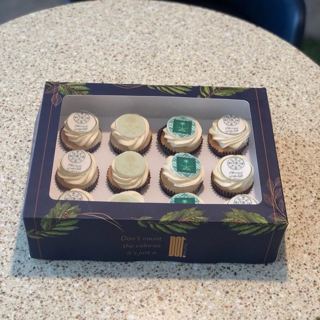 White and green cupcakes with Saudi emblem, by DOT Cake Art