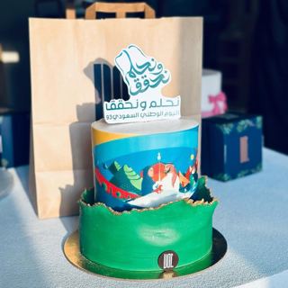 Green cake with Saudi National Day logo, by DOT Cake Art