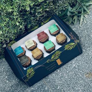 Box of cupcakes with assorted Arabic phrases, by DOT Cake Art