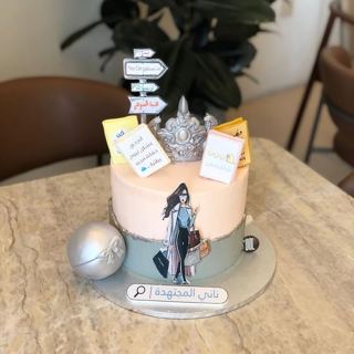 Cake with studious girl figure, signposts and crown, by DOT Cake Art