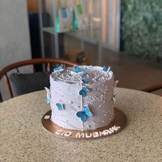 Lilac Eid cake with blue butterflies, by DOT Cake Art