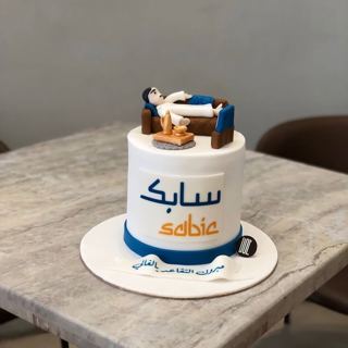 White cake with SABIC logo and relaxing figure, by DOT Cake Art
