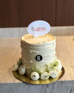 White cake with white flowers for retirement, by DOT Cake Art