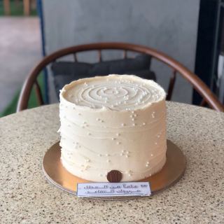 White pearl-dotted retirement cake, by DOT Cake Art