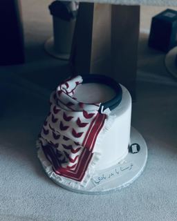 White cake with a red shemagh, by DOT Cake Art