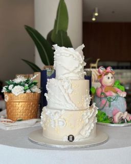 Three-tier white cake with flowers, by DOT Cake Art
