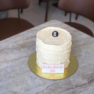 White cake with textured frosting, by DOT Cake Art